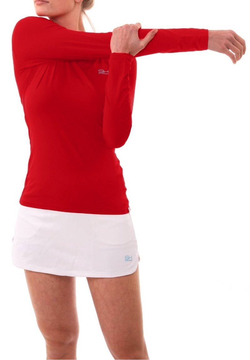 Red long-sleeve athletic top with a fitted design and round neckline, paired with a white skirt featuring a small blue logo.