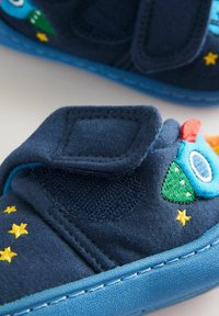 Navy blue toddler shoe with embroidered spaceship and yellow stars, featuring a blue sole and a Velcro strap closure.
