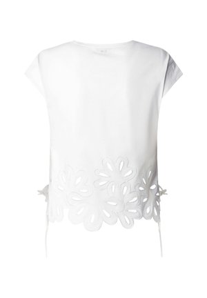 Maglietta bianca a maniche corte con grandi motivi floreali a intaglio lungo l'orlo inferiore e legacci laterali.