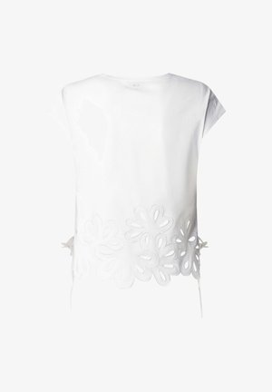 Maglietta bianca a maniche corte con grandi motivi floreali a intaglio lungo l'orlo inferiore e legacci laterali.