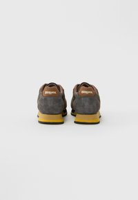 Pair of gray and brown suede sneakers with yellow and black soles, viewed from the back, featuring "Blauer USA" branding on the heel.