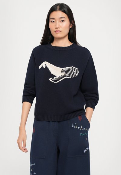 Navy knit sweater with a cream and stripe pattern of a bird. Crew neck, three-quarter sleeves, ribbed cuffs and hem.