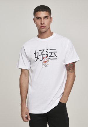 White cotton t-shirt featuring a graphic of a lucky cat and Chinese characters. Short sleeves and a relaxed fit. Black pants worn.