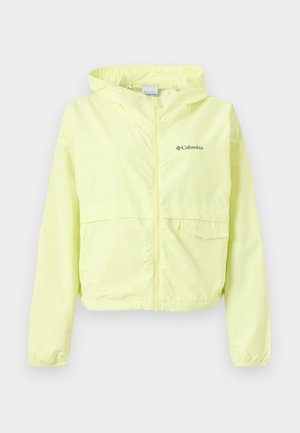 Világos sárga Columbia kapucnis szélkabát elöl cipzárral és két zsebbel, fehér háttér előtt bemutatva.