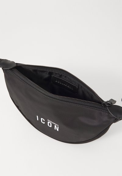 Must must ema sümptomiga mustad nailonist vöö kott, sulgudes kaarekujuliste kujunditega. Omab ülemist lukku, valget "ICON" logo ja vastupidavat, tekstuurset viimistlust.