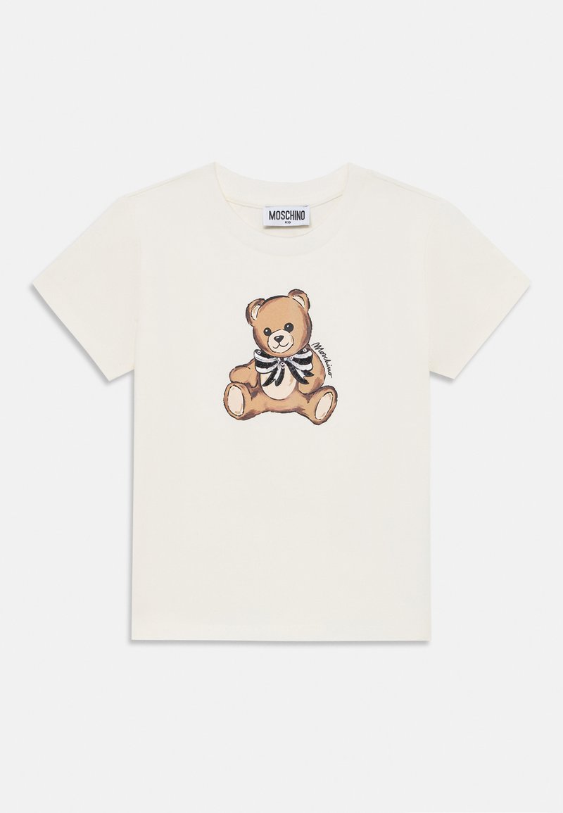 Balts kokvilnas T-krekls ar brūna lāča grafiku un melni baltu svītrainu tauriņu. Īsas piedurknes un klasiskā apaļā izgriezuma dizains.