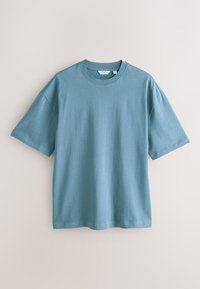 Világoskék pamut rövid ujjú póló, kerek nyakkivágással és laza fazonnal. Simogatott felület, egyszerű dizájn, minta vagy díszítés nélkül.