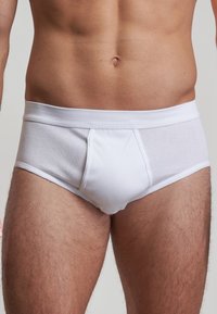 White cotton briefs featuring a soft, elastic waist, with a smooth texture and a front panel design for comfort and fit.