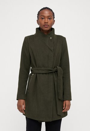 Olive green wrap coat with a high collar, side pockets with zippers, and a tied belt. Made of textured fabric, featuring a clean design.