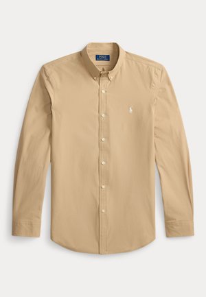 Camicia beige a maniche lunghe con bottoni sul davanti, colletto e piccolo logo ricamato sul petto sinistro.