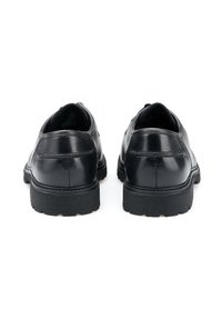 Scarpe in pelle nera con finitura liscia, punta arrotondata e suola in gomma testurizzata con profondi intagli per la presa. Altezza del tacco uniforme.