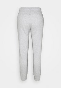 Jogging en coton gris avec une taille à cordon de serrage, jambes fuselées et poignets élastiques. Design simple, sans motifs ni accents visibles.
