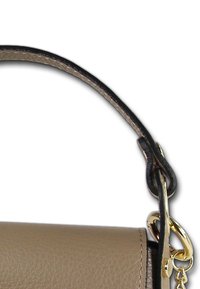 Sac à main en cuir marron avec une texture lisse, présentant un bord noir et un fermoir en métal doré sur la sangle. Design simple et couleur neutre.