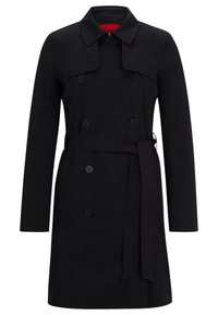 Trench-coat noir à double boutonnage avec col, fermetures à boutons, ceinture à la taille et manches longues, présenté sur un fond blanc.