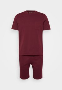 Burgundy cotton t-shirt with short sleeves and a chest pocket, paired with matching knee-length shorts, both in a smooth, even texture.