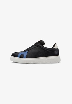 Black leather sneaker with blue accent, rounded toe, white rubber sole, and black laces. Features stitching along the upper and logo on the heel.