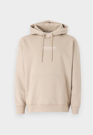 Bež dukserica s kapuljačom od mješavine pamuka, s prednjim kenguruh džepom i kapuljačom s vezicom. Ispisani logo na prsima. Mekana tekstura.