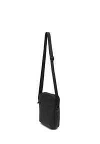 Black shoulder bag with adjustable strap, rectangular shape, zippered top, front pocket, smooth texture, minimalistic design.