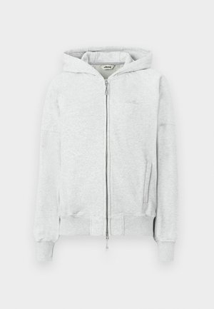 Light grey zip-up hoodie with a hood, ribbed cuffs and hem, two front pockets, and a subtle logo on the chest. Made from soft fabric.
