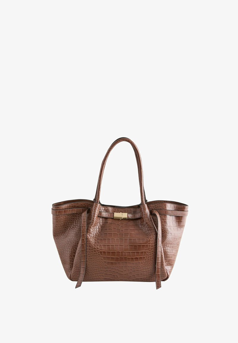 Braune Tasche mit Krokodilprägung, zwei Griffen, einem goldenen metallischen Verschluss und einem strukturierten Design. Glatte Textur mit abgerundeten Kanten.