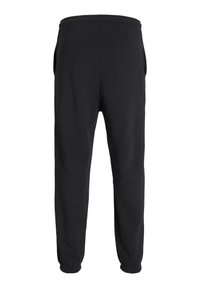 Zwarte sweatpants met een elastische tailleband, zijzakken en taps toelopende benen die eindigen in elastische boorden. Zachte stof met een gladde textuur.