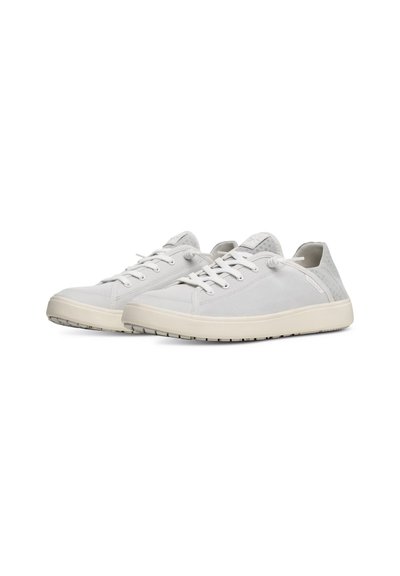 White sneakers made of canvas with a textured design, featuring round toe, lace-up closure, and a flexible rubber sole.
