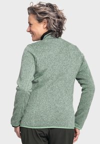 Grüne Fleecejacke mit strukturiertem Muster, schwarzem Kragen und kontrastierendem grünen Besatz an den Ärmelbündchen und dem Saum. Verfügt über eine taillierte Passform.