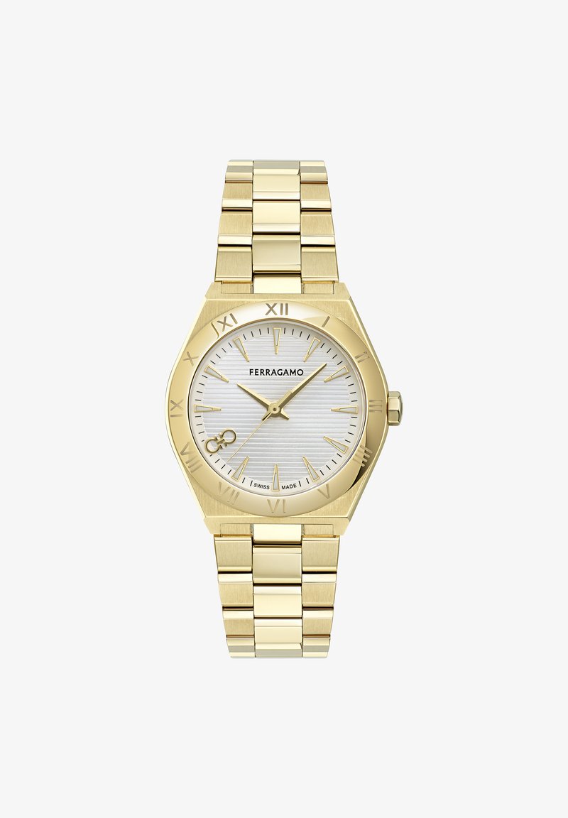 Kuldtooniline roostevabast terasest kell, millel on kaheksanurkne korpus, hõbedane tekstuuriga taldrik, Rooma numbrid ja lingitud rihm.