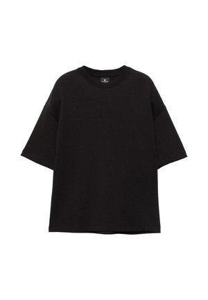 Črna ohlapna majica s kratkimi rokavi, okroglim izrezom in spuščenimi rameni, položena na belo podlago.