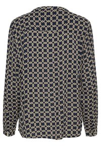 Blouse bleu marine avec un motif géométrique crème, manches longues et coupe décontractée avec un détail de empiècement au dos.