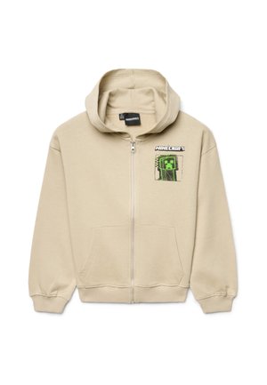 Felpa con cappuccio beige con zip, tasche frontali, logo Minecraft e personaggio Creeper verde pixelato sul lato sinistro del petto.