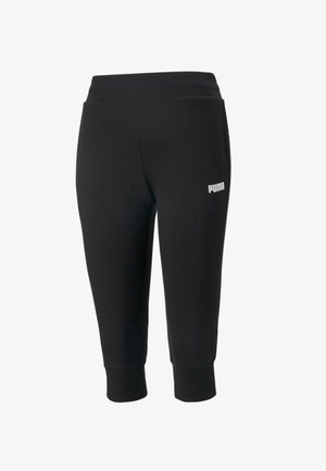 Pantalon de sport noir avec une large ceinture, des chevilles fuselées et des poches latérales. Présente un petit logo blanc sur la jambe gauche.