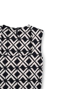 Top senza maniche con scollo quadrato, caratterizzato da un motivo geometrico in bianco e nero di diamanti interconnessi su un tessuto liscio.