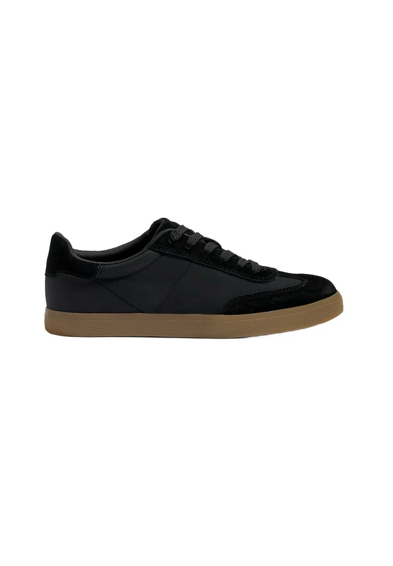 Black sneaker with a smooth and suede texture, low-top design, flat brown rubber sole, and standard lace closure.