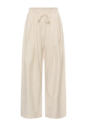 Laia kellukujuliste jalgadega beežid püksid, millel on elastne vöökohal ja reguleeritava nööriga sulgemine, valmistatud õhukesest kangast.