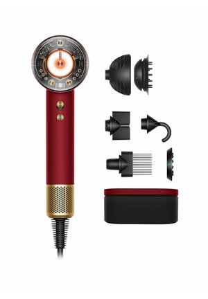 Red hairdryer with a circular head featuring a light and controls, gold accents, and multiple black detachable attachments arranged beside.