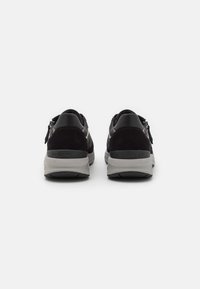 Black and grey mesh and suede sneakers with a shaped heel, zipper detail, and "rollingsoft" branding on the sole.
