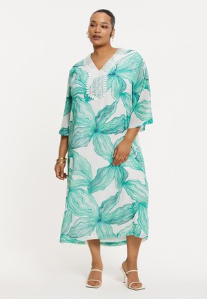 Fließender weißer Kaftan mit grünem Blumenmuster, V-Ausschnitt und Spitzendetails. Leichter Stoff und weite Ärmel für hohen Tragekomfort.