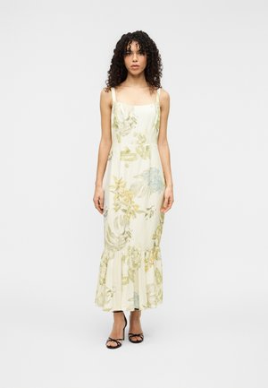 Šaty s kvetinovým vzorom, štvorcovým výstrihom, úzkymi ramienkami a rozšíreným lemom. Vyrobené z ľahkej látky v krémovej farbe so zelenými a modrými vzormi.