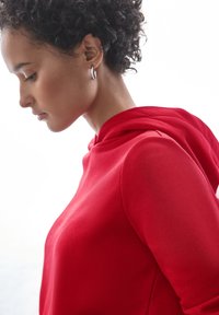 Felpa rossa con scollo rotondo e coulisse. Tessuto morbido con silhouette aderente. Maniche corte con orlo pulito.