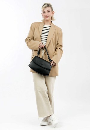 Black leather handbag with a braided handle, rectangular shape, smooth texture, and a front flap closure, held by a person in a beige blazer.