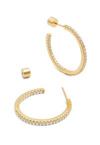 Pendientes de aro dorados que presentan una fila de rhinestones claros a lo largo del borde frontal. Los pendientes tienen un acabado pulido y una forma redondeada.