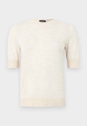 Pull à manches courtes de couleur crème avec col rond, poignets et ourlet côtelés, étiquette « SUPREME MERINO » au col.