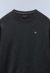 Donkergrijze trui met ronde hals en een klein Noors vlagembleem op de borst en een wollen label aan de binnenkant van de halslijn.