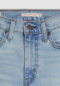 High-rise straight leg jeans in light blue denim. Features orange stitching, button closure, and a back patch with size label.