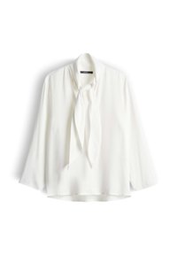 Blusa bianca in seta con dettaglio al collo a fiocco, maniche lunghe e vestibilità leggermente ampia. Texture liscia e design minimalista, senza motivi né accenti.