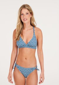 Bikini set met een blauw-wit geometrisch patroon. De top heeft een v-hals ontwerp, terwijl de onderkant zij-tie accenten heeft.