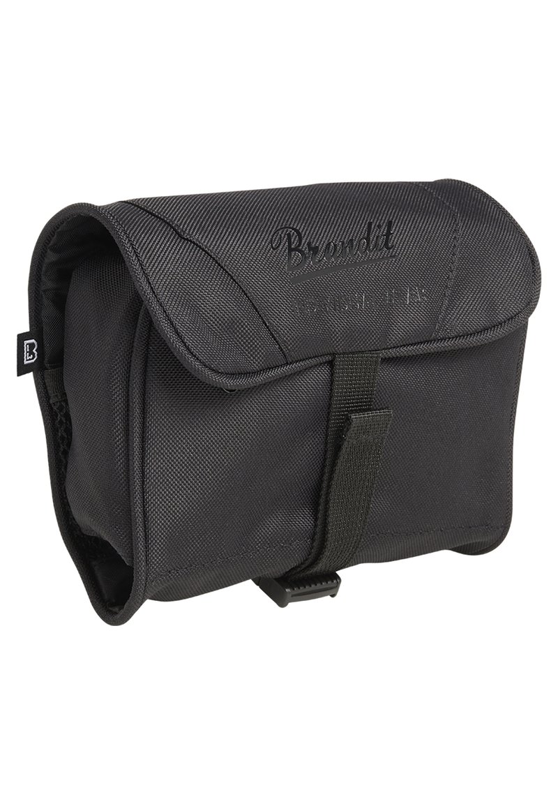 Black fabric toiletry bag with a flap closure, textured surface, and branded lettering. Features a front strap and compact design.
