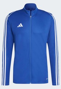 Blue zip-up jacket made from smooth fabric, featuring white striped accents on sleeves and a logo on the left side.