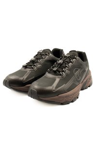 Black athletic shoes with a textured surface, featuring a rounded toe, chunky brown sole, and a lacing system with a toggle closure.